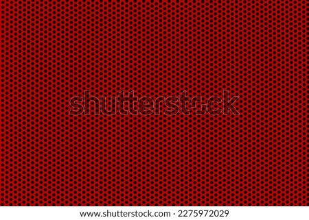 Background of wavy red metallic grid with holes. Metal mesh as background. Perforated metal back.  Royalty-Free Stock Photo #2275972029