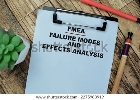 Concept of FMEA - Failure Modes and Effects Analysis write on paperwork isolated on Wooden Table. Royalty-Free Stock Photo #2275983919