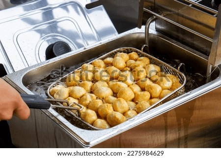 Fried Fish Ball In Boiled Oil On A Pan. Royalty-Free Stock Photo #2275984629