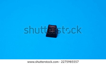 Black computer keyboard isolated on blue background. Copy space for text. Royalty-Free Stock Photo #2275985557