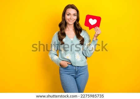 Photo of cheerful lovely girl arm hold paper like notification card isolated on yellow color background