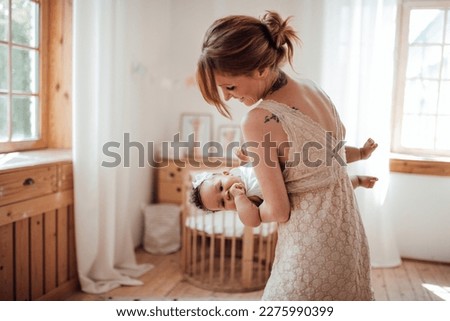 Diverse people portrait of mother with swarthy infant spending time in snugly apartment. Multi ethnic family having fun togetherness enjoying motherhood positive emotion motherly care at home