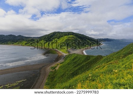 Cape Evstafiya in the Sea of ​​Okhotsk, Russia. Picturesque hills, with bright herbs and blue sea on Sakhalin. Royalty-Free Stock Photo #2275999783
