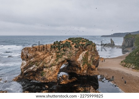 Picturesque Cape Velikan on the shore of the Sea of ​​Okhotsk in the Far East of Russia, Sakhalin Island. Picturesque coastal cliffs and the sea. Royalty-Free Stock Photo #2275999825
