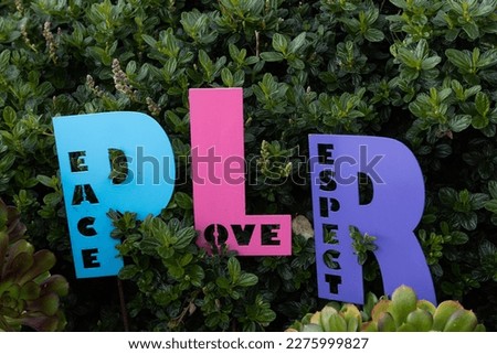 Colorful, wooden signs symbolizing peace, love and respect. 