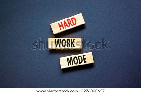 Hard work mode symbol. Concept words Hard work mode on wooden block on a beautiful black table black background. Business and Hard work mode concept. Copy space.