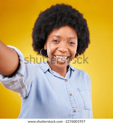 Portrait, selfie and black woman in studio happy, smile and confident against yellow background. Face, social media and girl influencer posing for photo, profile picture or blog update or vlog post