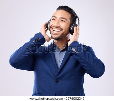 Executive man, music headphones and thinking on studio background of happiness, motivation and inspiration. Happy corporate worker listening to audio, sound and business podcast on radio with smile