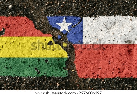 On the pavement there are images of the flags of Bolivia and Chile, as a symbol of the confrontation between the two countries. Conceptual image.