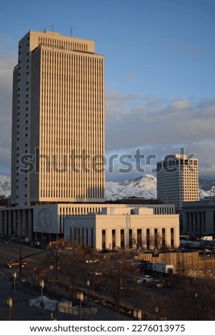 The office building of the church of Jesus Christ and the latter days saints in the city centre of Salt Lake City in the light of a sunset in the early evening with snowy mountains in the background