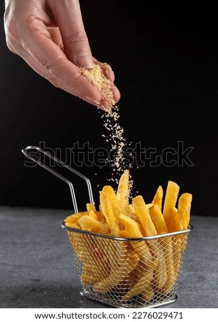 French fries . Fries in basket isolated on black background. fried potato picture for advertising 