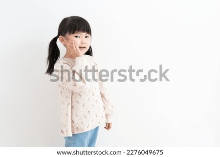 Cute Asian child on white background Royalty-Free Stock Photo #2276049675