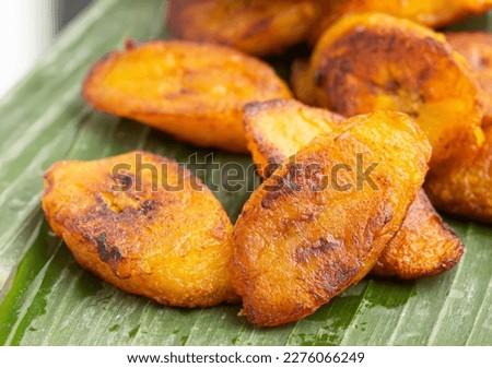 Dodo - Fried Plantains Chips is the Nigerian name for sweet, fried ripe plantains eaten in or alongside savory dishes, not dessert. Royalty-Free Stock Photo #2276066249