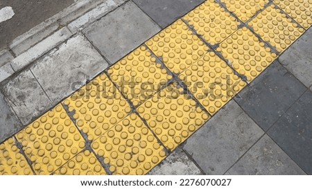 Special yellow lane for pedestrians with disabilities.