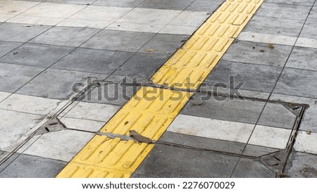 Special yellow lane for pedestrians with disabilities.