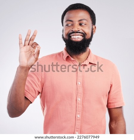 Perfect, happy and okay sign with black man in studio for deal, success and good news. Thank you, agreement and emoji with male isolated on gray background for celebration, opinion and confidence