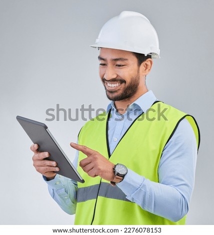 Construction worker, engineer and happy man in studio with tablet and helmet safety on white background. Smile, internet and contractor or architect in online planning for project management in India Royalty-Free Stock Photo #2276078153