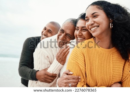 Love, happy family and hug at a beach by siblings with mature parents on holiday, smile and bonding. Hugging, care and affection by senior couple on retirement vacation while embracing adult children Royalty-Free Stock Photo #2276078365