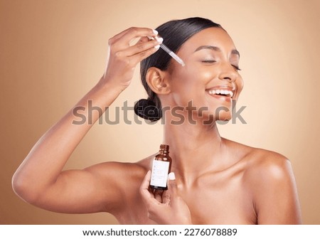Woman, dropper and retinol on face for skincare beauty or cosmetics against a studio background. Happy beautiful female model applying oil drop to skin for hydration, moisturizer or facial treatment Royalty-Free Stock Photo #2276078889