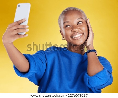 Smile, selfie and beauty of black woman in studio isolated on a yellow background. Photographer, social media and African female model taking pictures or photo for profile picture and happy memory.