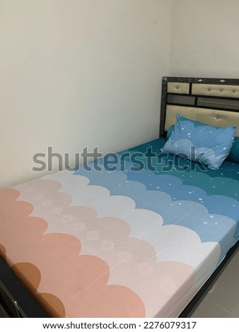Colorful bed interior with rainbow picture