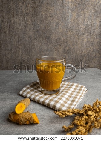 jamu kunyit asem or kunyit asam is traditional herbal drink made from tumeric curcuma and tamarind. herbal drink from indonesia