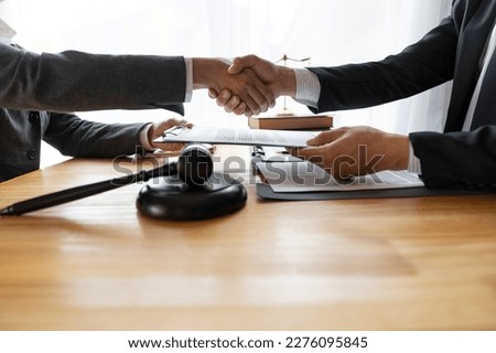 Lawyers shake hands with business people to seal a deal with partner lawyers. or a lawyer discussing contract agreements, handshake concepts, agreements, agreements Royalty-Free Stock Photo #2276095845