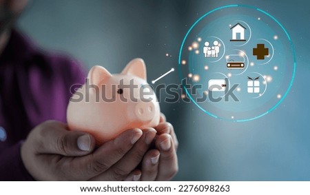 A man holding cute pink piggy bank with family life icons on hands. innovation ideas and inspiration saving money to the future. Banking, financial, and saving money concepts.