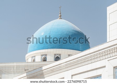 Awesome blue dome of Minor Mosque in Tashkent, Uzbekistan. The amazing white mosque is a popular tourist attraction of Central Asia. Royalty-Free Stock Photo #2276098715