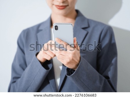 Business image of a young woman n using a smartphone