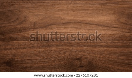 Walnut wood texture background.  Black walnut plank table top background. Dark wood plank table top.