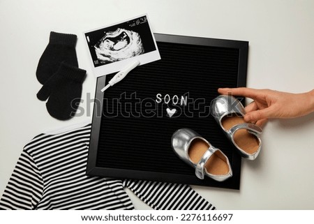 pregnancy announcement background with baby items. Top View. Baby is coming. enjoying future parenthood. Baby Coming soon concept. Baby announcement sign. ultrasound pregnancy image.