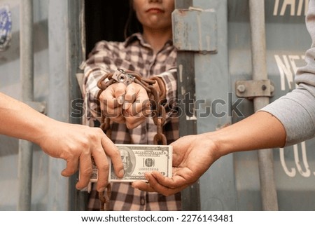 Woman trapped in cargo container wait for Human Trafficking or foreigh workers, Woman holding master key wait for holp help, woman chained to her wrist Royalty-Free Stock Photo #2276143481
