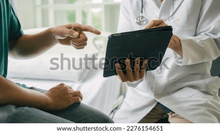 Male patient consulting a medical specialist at hospital. Taking a patient's history