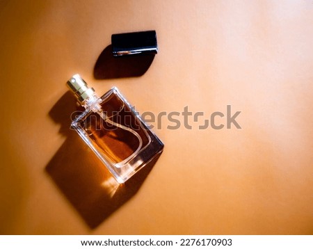 perfume product suit for advertising , mockup with open cap on a brown and golden background