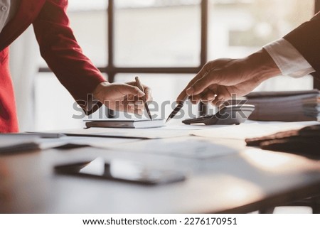 Group business people are reviewing monthly sales documents analysis and marketing plans for more sales growth, they are the founders of young companies co-founding startups. Sales management concept. Royalty-Free Stock Photo #2276170951
