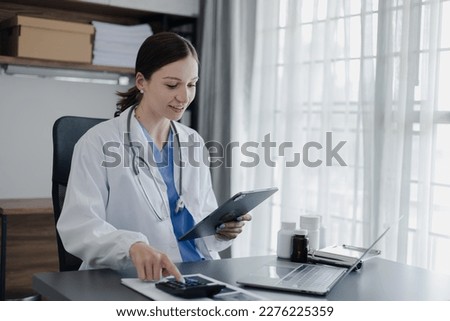 Doctor woman using digital tablet with laptop and conducts video consultation an online conference, Healthcare technology and medical concept. 