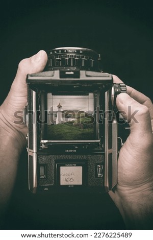 hands hold a medium format film camera