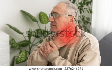 Male face with a painful red spot on the neck. Concepts of problems with thyroid or sore throat. Royalty-Free Stock Photo #2276246291