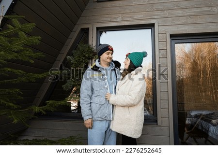Couple in love on terrace off grid tiny house in the mountains.
