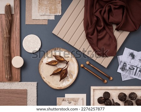 Creative flat lay composition with textile and paint samples, panels and cement tiles. Stylish interior designer moodboard. Blue, beige and brown color palette. Copy space. Template. 
