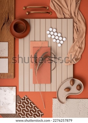Modern flat lay composition in orange and beige color palette with textile and paint samples, lamella panels and tiles. Architect and interior designer moodboard. Top view. Copy space. 