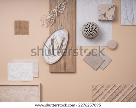 Creative flat lay composition with textile and paint samples, panels and cement tiles. Stylish interior designer moodboard. Light beige and gray color palette. Copy space. Template. 