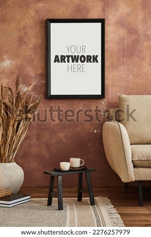 Stylish composition of modern living room interior. Mock up poster frame, dry plants, sofa and personal accessories. Creative wallpaper. Home staging. Template. Copy space. 