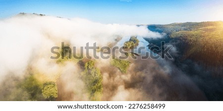 In the morning, a thick white fog hovers over the river. Location place Dniester canyon national park, Ukraine, Europe. Aerial photography, drone shot. Photo wallpaper. Discover the beauty of earth.