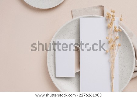 white paper mockup for greeting card, wedding or menu, on a white plate with cream background. mockups.