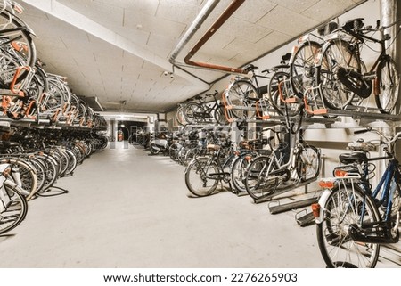 many bikes parked in a bike storage area, all stacked up and ready to be stored on the wall or ceiling Royalty-Free Stock Photo #2276265903
