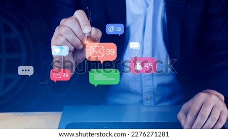 People using social media and digital online marketing concepts on laptop with icons such as notifications, messages, comments on the smartphone screen.
