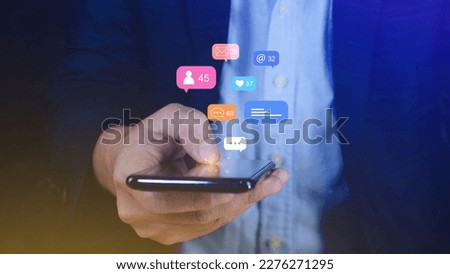 People using social media and digital online marketing concepts on mobile phones with icons such as notifications, messages, comments on the smartphone screen. Royalty-Free Stock Photo #2276271295