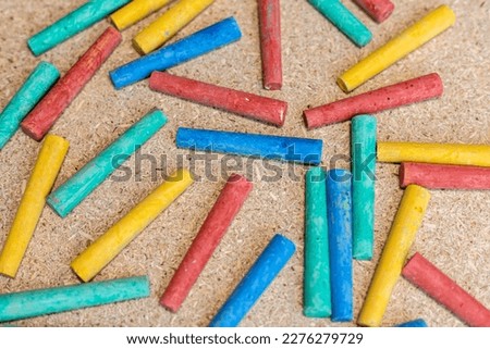 Multicolor chalks on a cork board